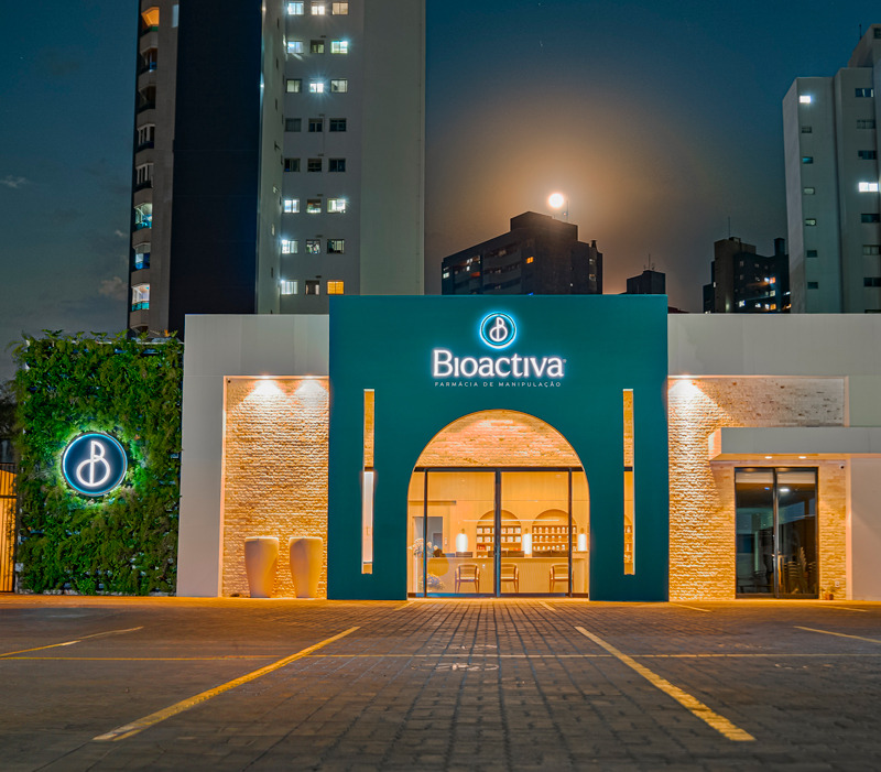 Fachada da farmácia Bioactiva iluminada à noite